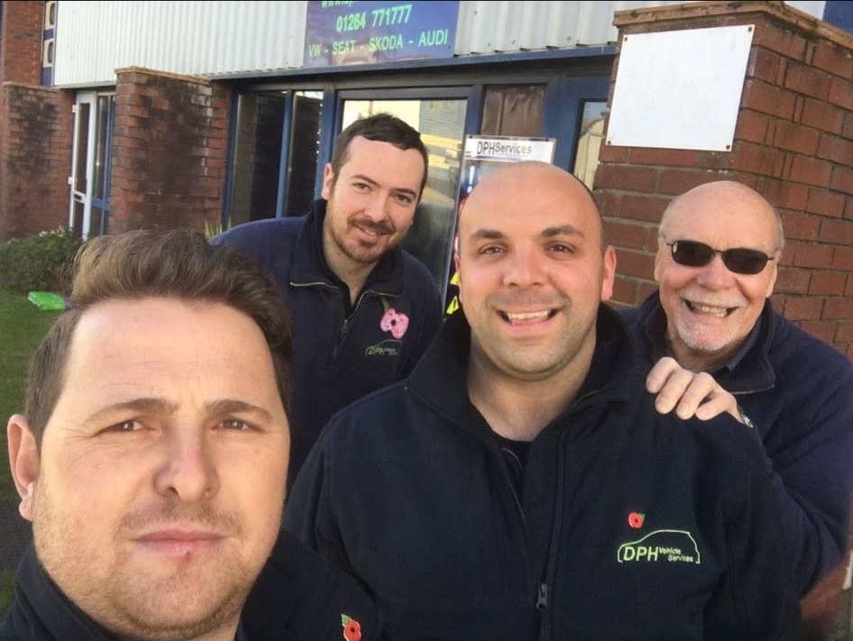 Four of the DPH team in branded jackets outside the unit